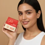 A girl holding the jar of Kumkumadi Ayurglow Cream close to her face(100ml)