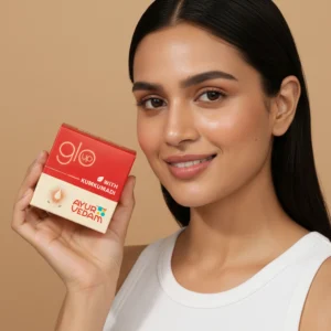 A girl holding the jar of Kumkumadi Ayurglow Cream close to her face(100ml)