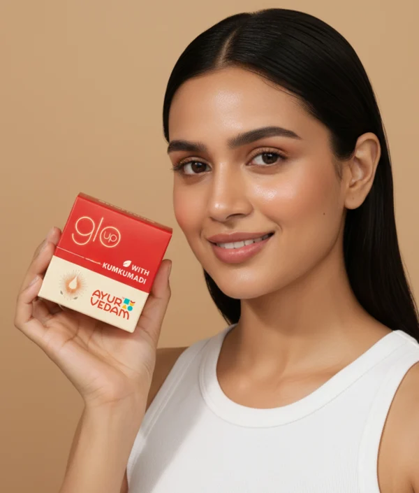 A girl holding the jar of Kumkumadi Ayurglow Cream close to her face(100ml)