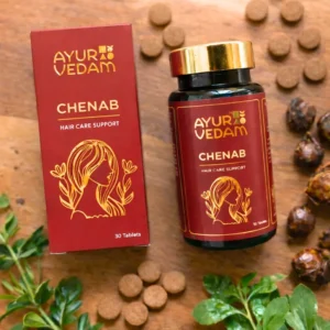 Ayurvedam Chenab Ayurvedic hair growth tablets with natural ingredients including Reetha (Soapnuts) and green leaves on a wooden surface.