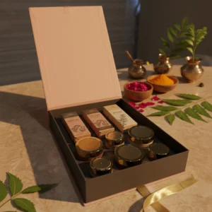 A Giftbox of Pink Purity by Ayurvedam containing Ayurvedic wellness products, displayed on a natural jute surface with neem leaves, white flowers, smooth stones, clay pots, and almonds for a traditional and earthy aesthetic.