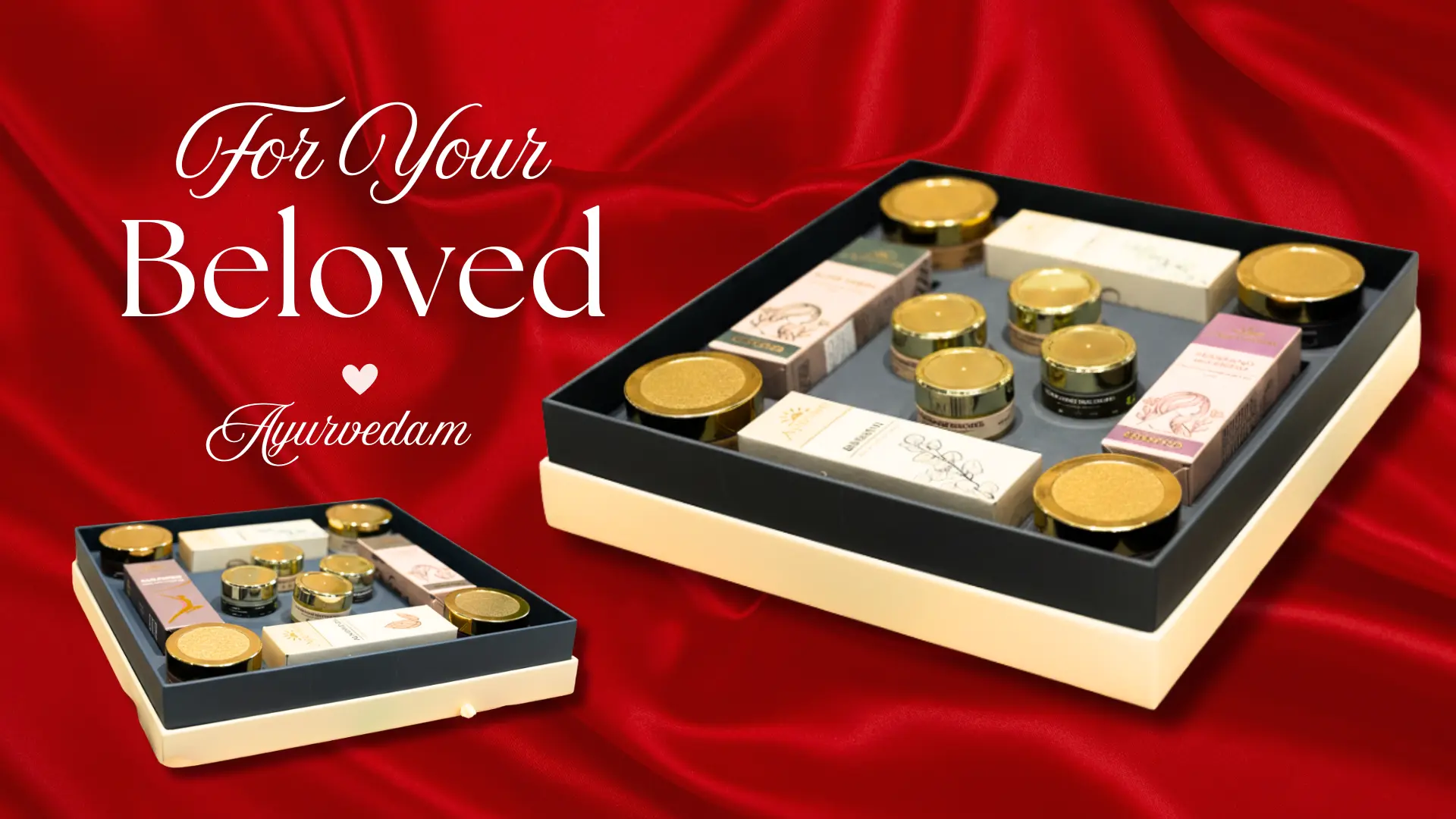 Ayurvedam branded gift box containing Ayurvedic wellness products, displayed on a natural jute surface with neem leaves, white flowers, smooth stones, clay pots, and almonds for a traditional and earthy aesthetic.