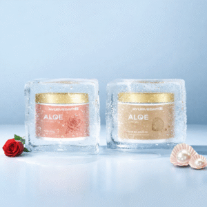 Two jars of Ayurvedam Aloe Rose Gold and Aloe Pearl Silver variants, encased in melting ice blocks with a fresh red rose and saffron strands in the foreground.